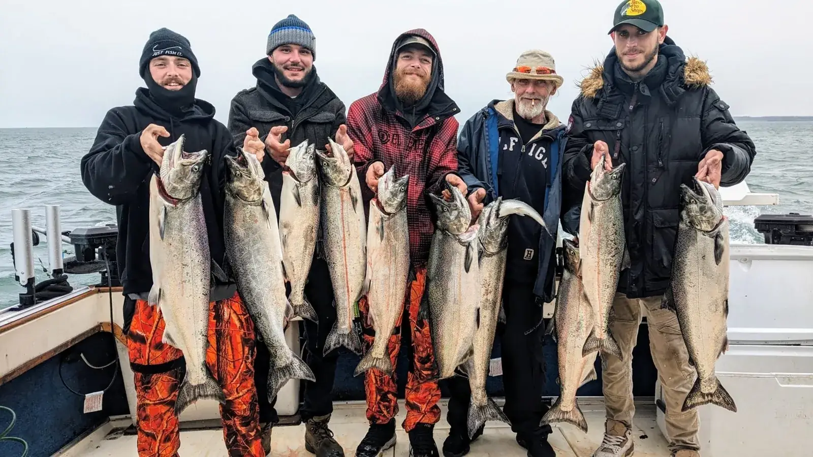 Five anglers holding a full limit of Lake Ontario chinook salmon aboard King Slayer