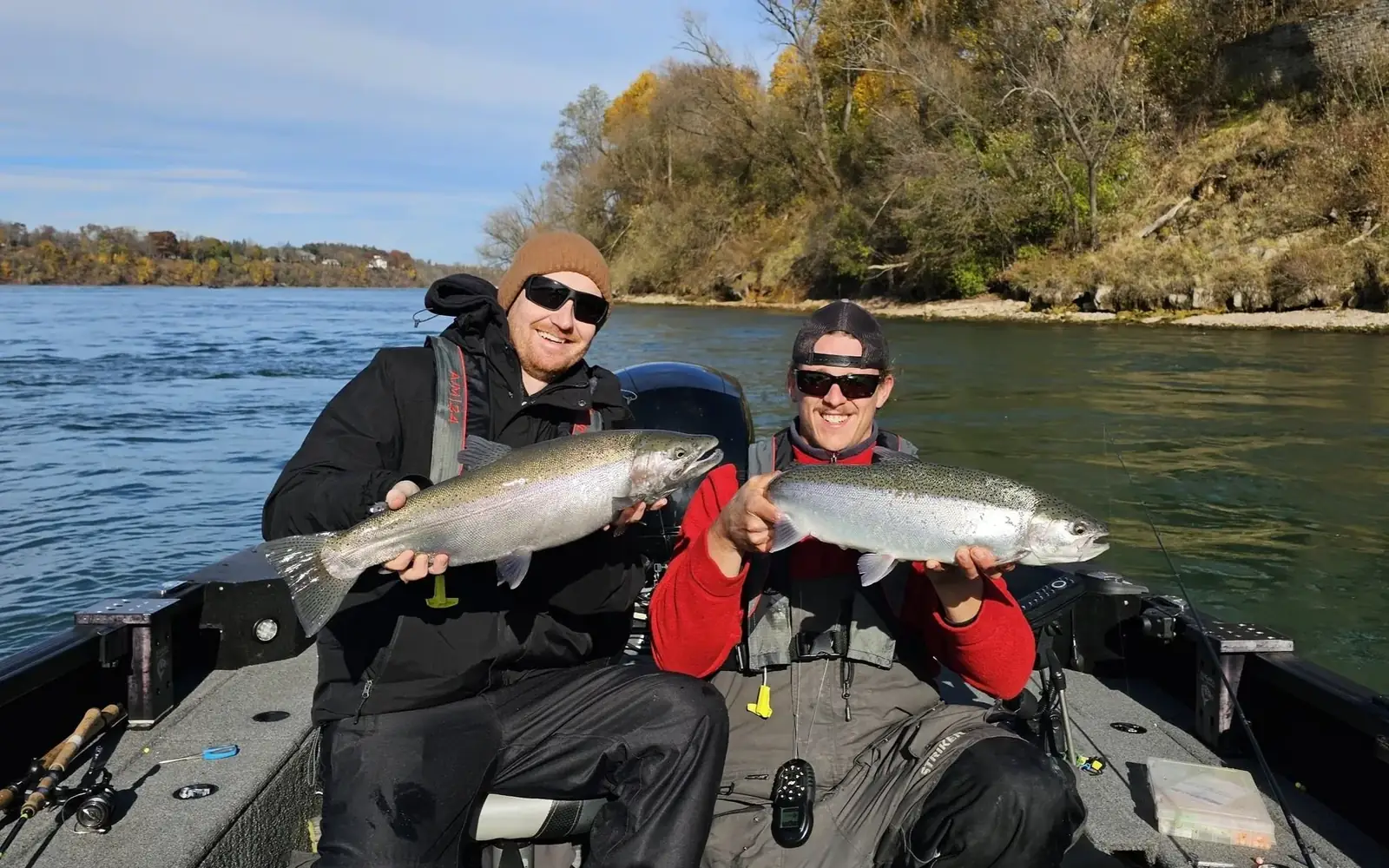 Two anglers holding steelhead below the Niagara gorge bluffs