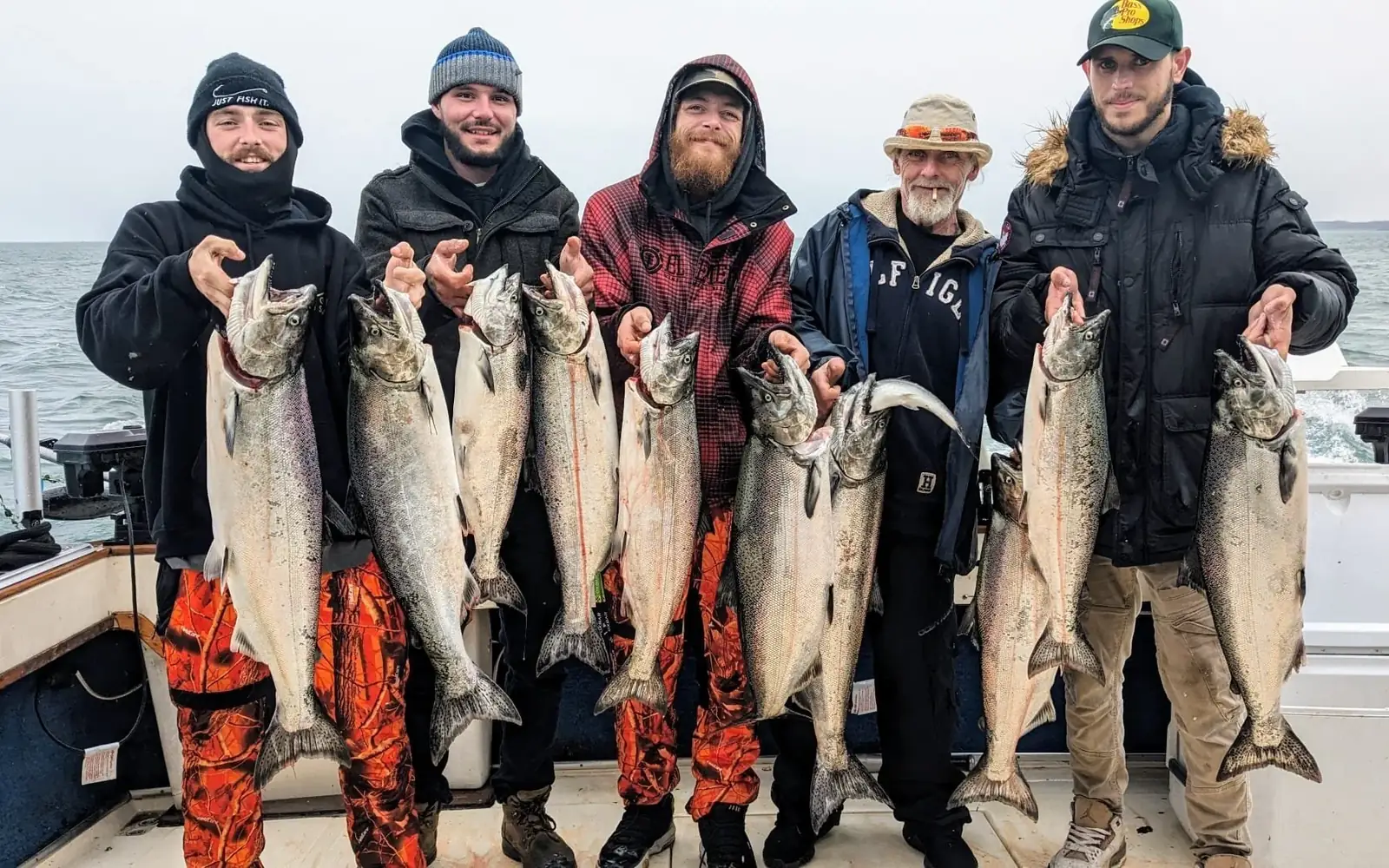 Five guests lined up with their limit of salmon after a Lake Ontario charter