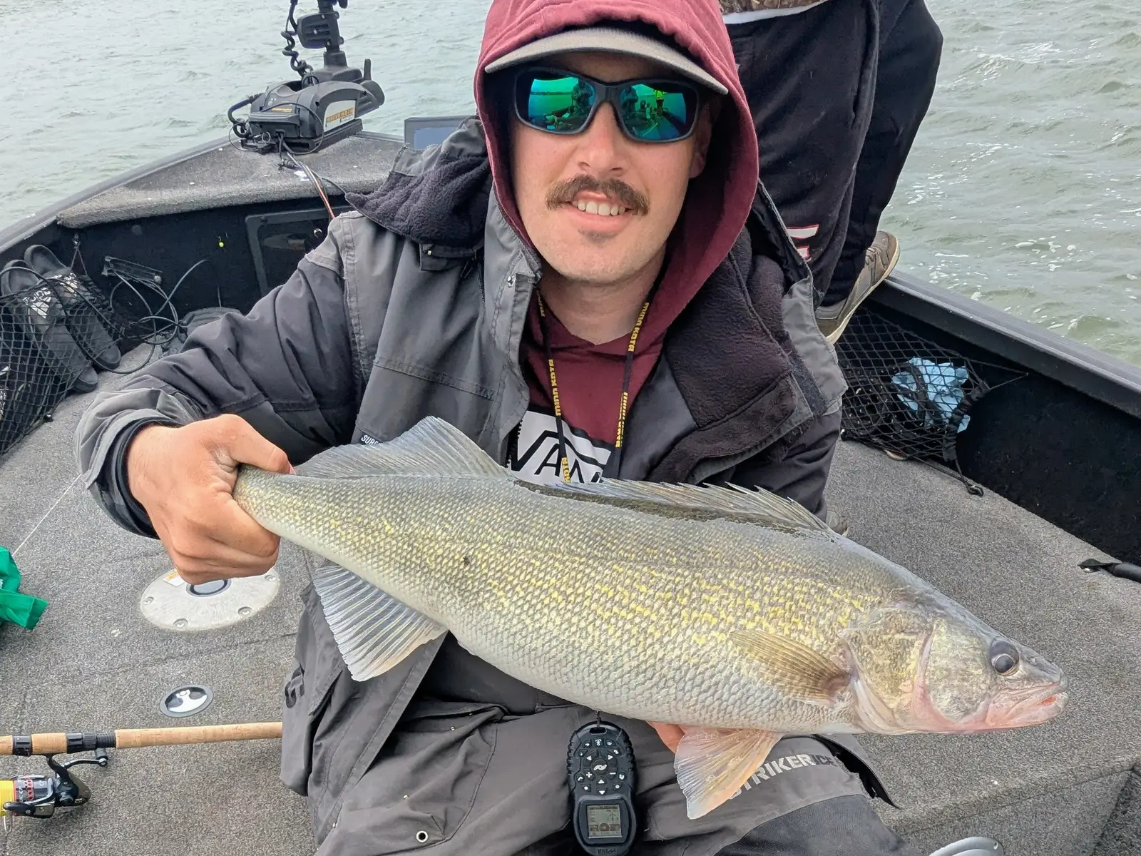 Angler holding a Lake Erie walleye aboard the King Slayer Alumacraft