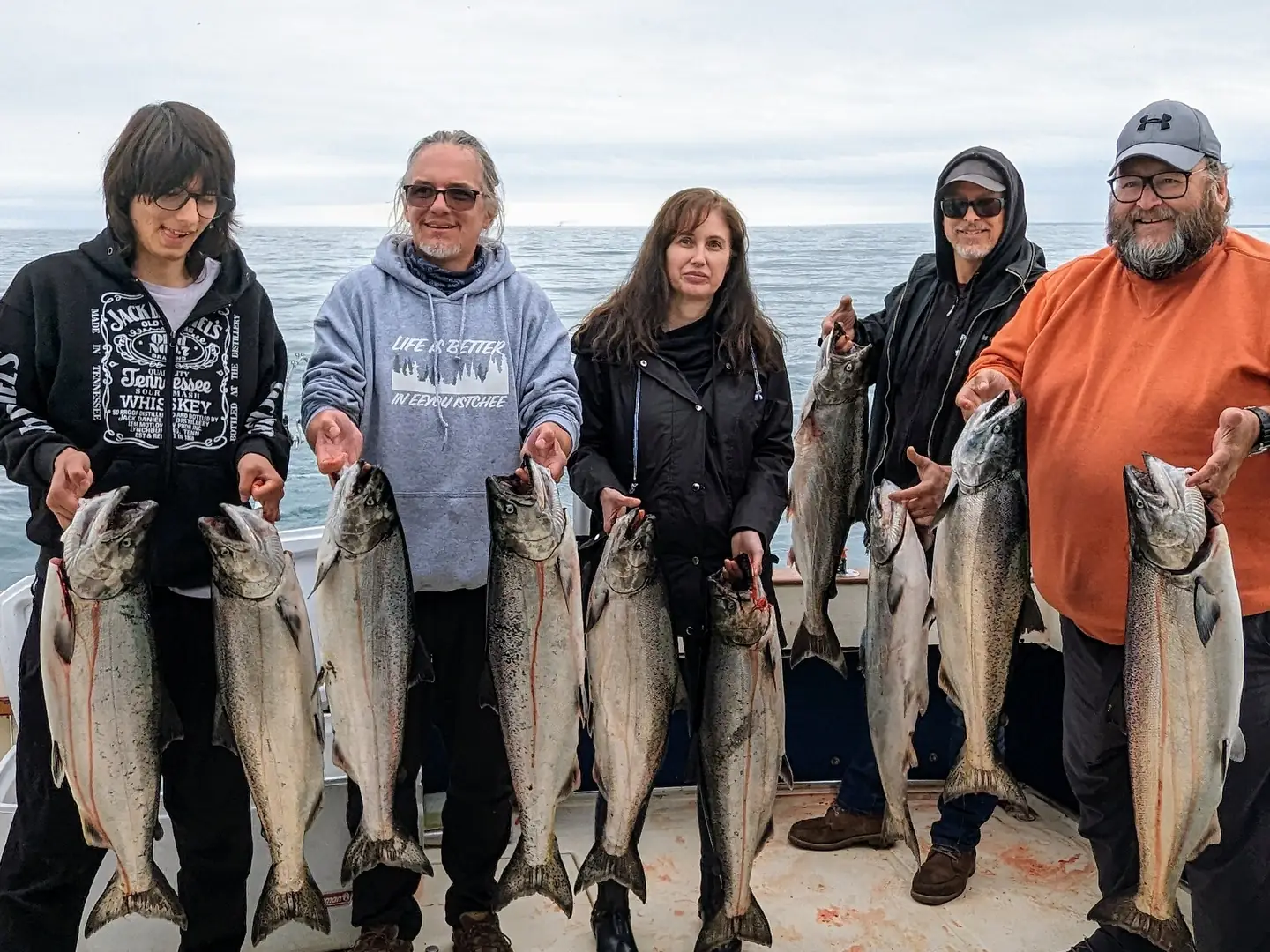 Three generations of one family lined up with their catch of Lake Ontario salmon